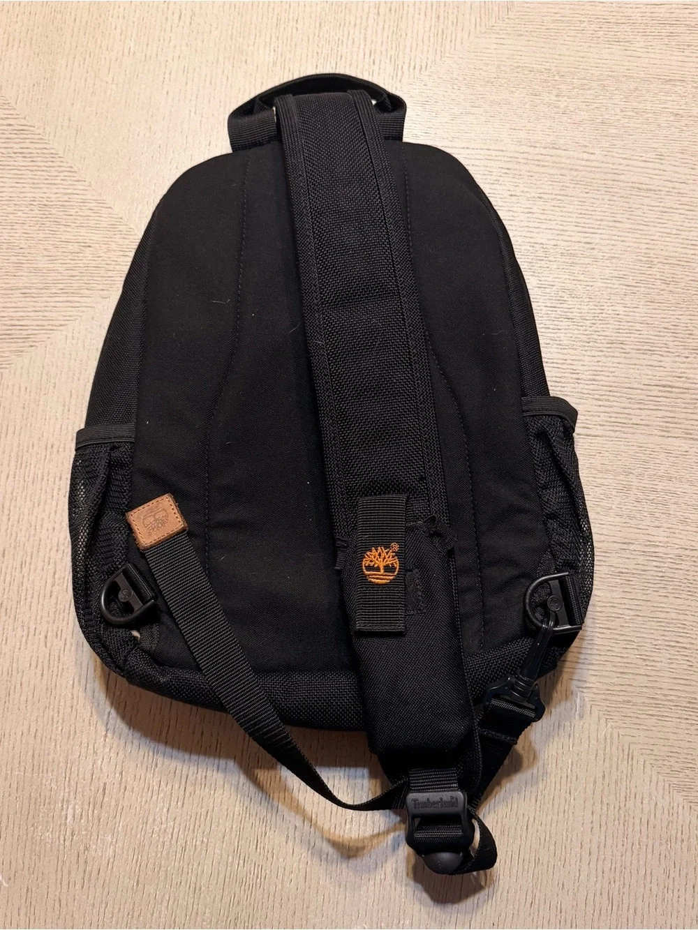 Timberland Black Sling Backpack with Brown Leather Accents